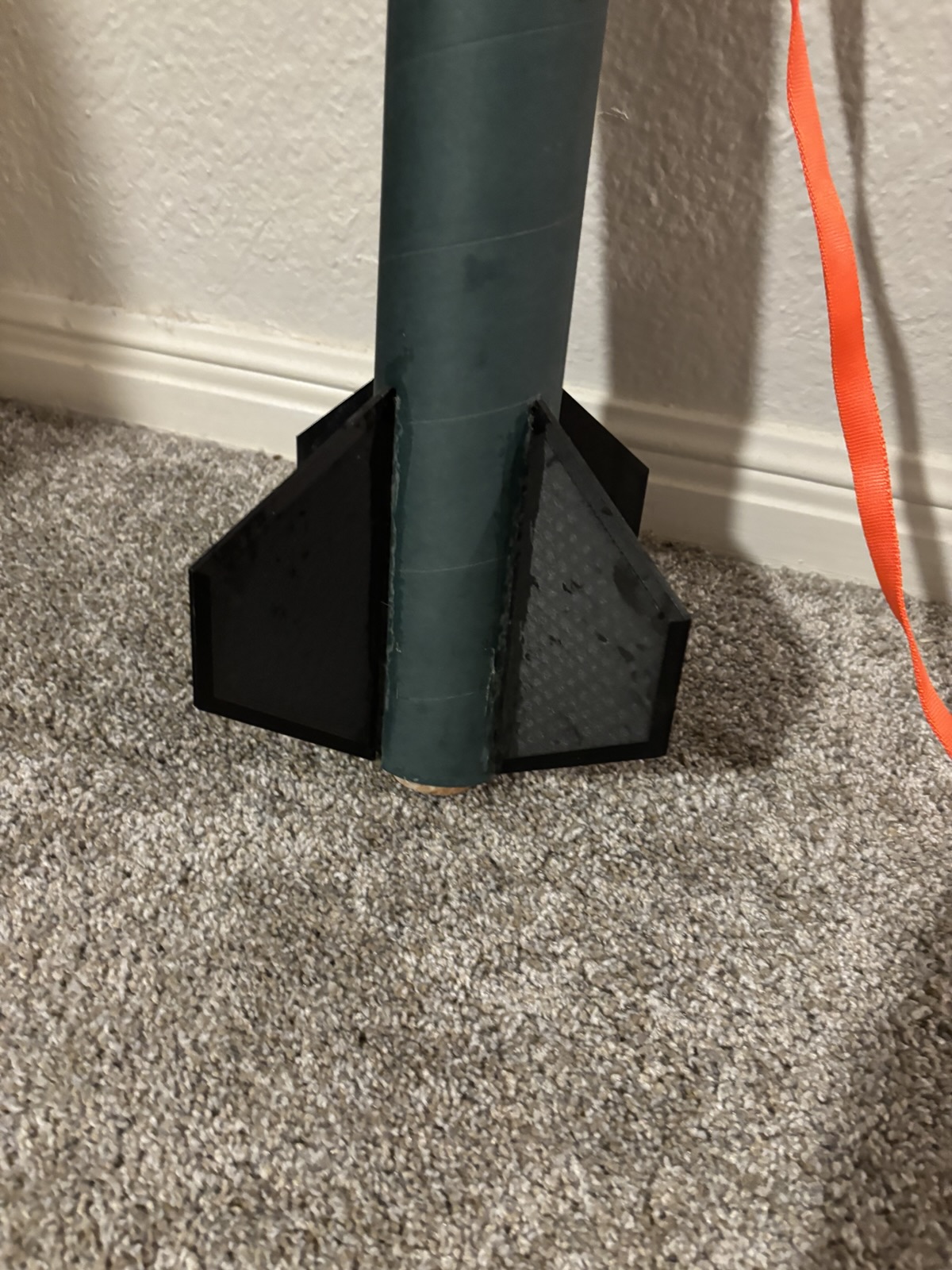 Close-up of the rocket's fin can with three black fins