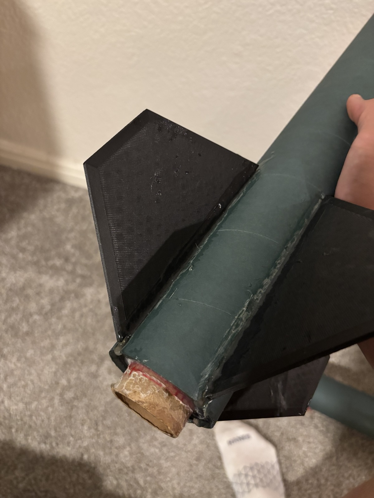 Close-up of epoxy fillets along the fin roots and the aft end of the motor mount