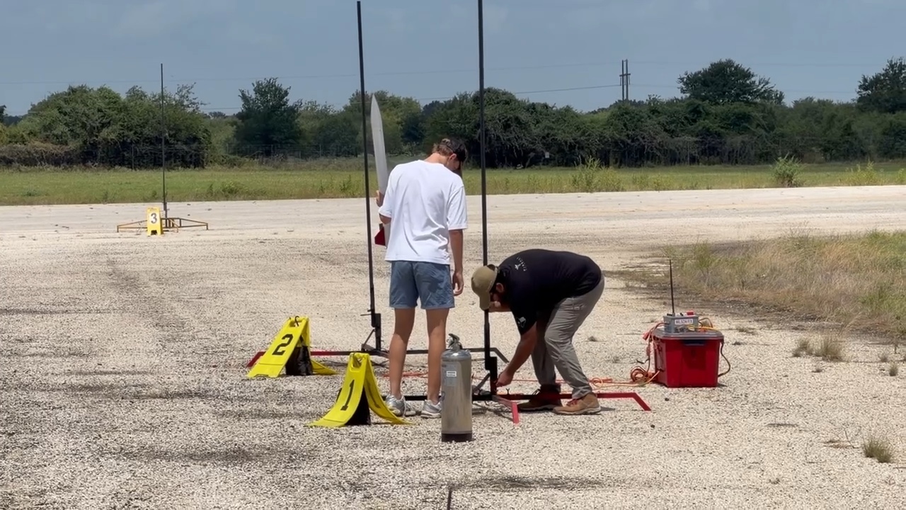 A member and a range volunteer making final checks at the base of the vertical launch rail